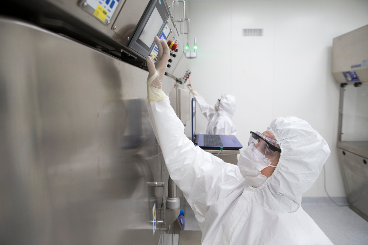 Cleanroom specialist working with hot cell manipulator